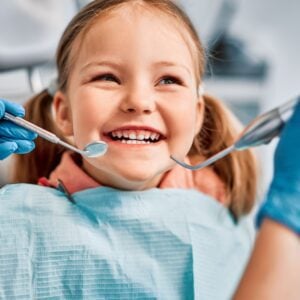 A smiling little girl in a dental office.
