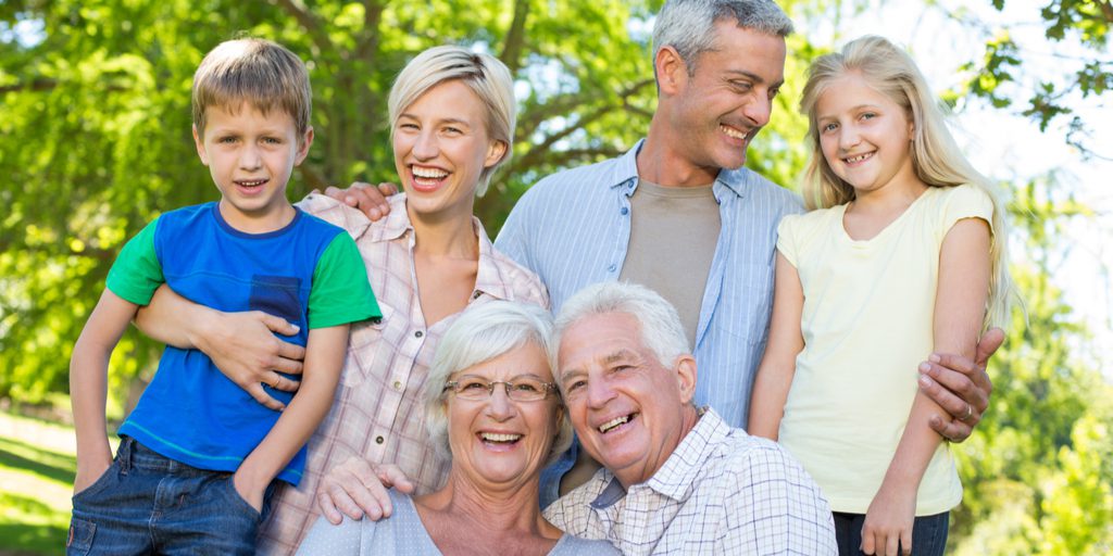 A photo of a family smiling with white teeth.