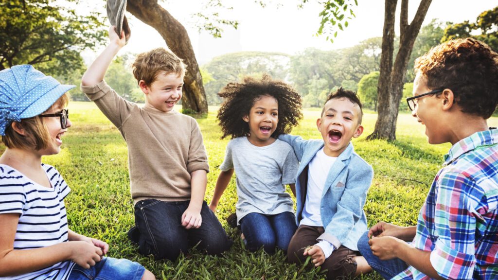 Children sitting outside during warm spring weather.