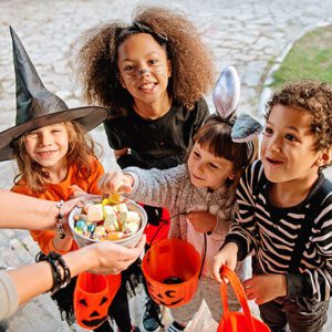 A group of children trick or treating for Halloween candy.